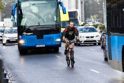 Un ciclista circula entre el tráfico en Madrid. 