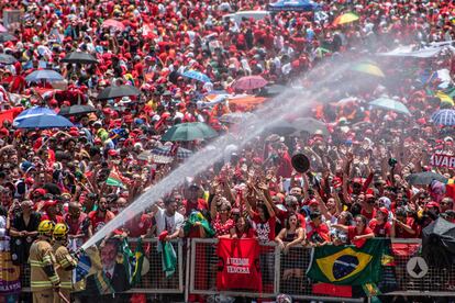 Dos bomberos refrescan a los asistentes que esperan esperan sobre la Esplanada dos Ministérios la toma de posesión de Lula da Silva. 