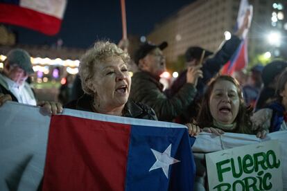 Chileans outside the seat of government, La Moneda Palace, in Santiago, Chile, on Sunday. 