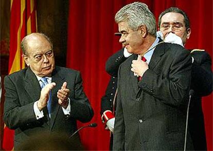 Jordi Pujol aplaude al nuevo presidente de la Generalitat, Pasqual Maragall, durante la toma de posesión.