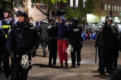 Police detain a protestor, as other police officers enter the campus of Columbia University on April 30, 2024.