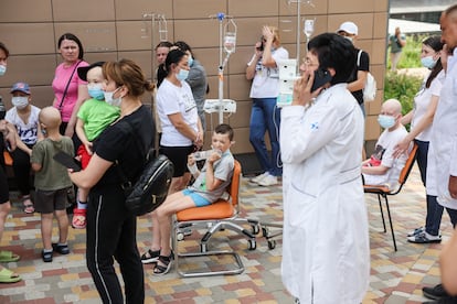 Relatives and patients after being evacuated from the Ohmatidit Children's Hospital in Kyiv this Monday. 