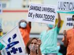 A health worker holding a placard reading "Universal healthcare for all" attends a protest against the regional health authority's lack of support and demanding better working conditions outside Gregorio Maranon hospital in Madrid, Spain September 15, 2020. REUTERS/Juan Medina