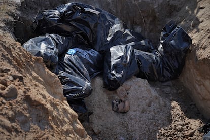 mass grave outside the Church of Saint Andrew in Bucha Ukraine Russia War