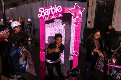 A protester poses inside a satirical Barbie doll box in Lima on Wednesday. 
