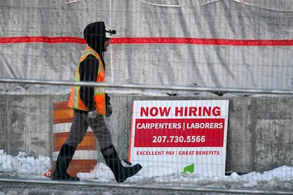 A worker passes a hiring sign at a construction site, Wednesday, Jan. 25, 2023, in Portland, Maine.