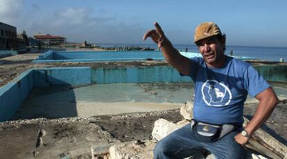 El cubano Miguel, entre las ruinas de las  instalaciones costeras tras los últimos huracanes.