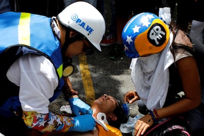 Un hombre herido es atendido durante la protesta contra el gobierno de Maduro.