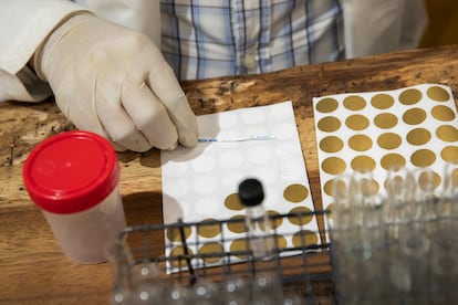 Scientific communicator, Astron Martínez, holds a test strip with a false positive for fentanyl.