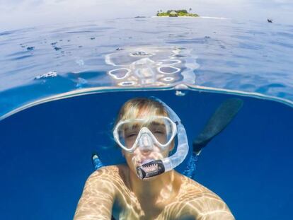 Una mujer se sumerge debajo del agua del mar mediante la técnica del 'snorkel'.