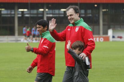 Marcelo Bielsa, junto a su ayudante a un niño.