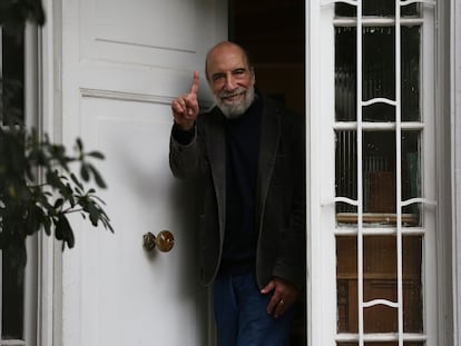 El poeta chileno Raúl Zurita saluda desde la puerta de su casa, este martes.