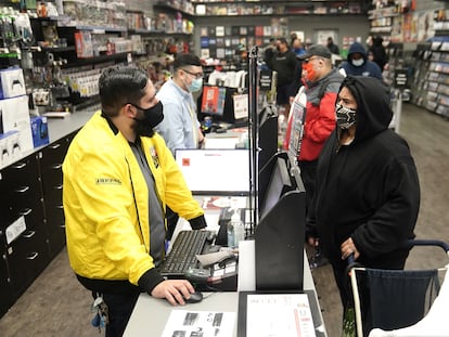 Inside a GameStop store people line up to purchase a Sony PS5 gaming console in the Manhattan borough of New York City, New York, U.S., November 12, 2020. REUTERS/Carlo Allegri