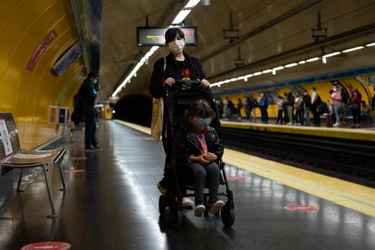 Valentina y su madre, Nani, esperan a que llegue el metro en la estación de Callao de Madrid.