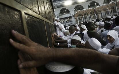 Peregrinos musulmanes alcanzan la Kaaba, el santuario más sagrado del Islam, para recibir su bendición al tocarlo, en la Gran Mezquita de la ciudad sagrada de La Meca (Arabia Saudí).