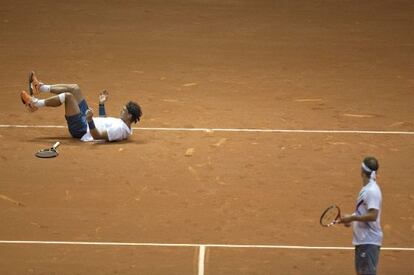 Rafael Nadal slips on court during his doubles match with partner David Nalbandian. 