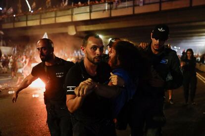 Police detain a person during a demonstration following a parliament vote on a contested bill that limits Supreme Court powers to void some government decisions, in Tel Aviv, Israel, on July 25, 2023.