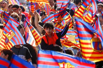 Un nen oneja una bandera de l'equip blaugrana.