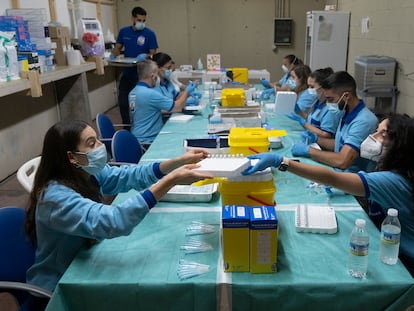 Covid-19 vaccines are prepared at a vaccination point in Seville, southern Spain.