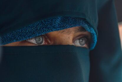 Una mujer vestida con burka camina por una calle en medio de las lluvias monzónicas en Srinagar (India), este viernes.