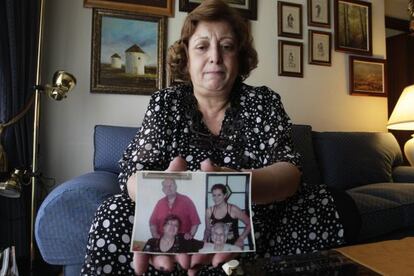 Pilar Arriols holds up a family photo.