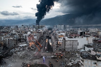  Smoke billows from the Iskenderun Port as rescue workers work at the scene of a collapsed building on February 7.