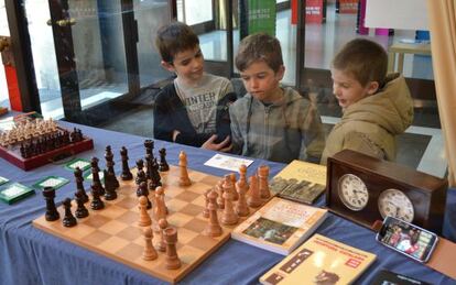 Tres ni&ntilde;os visitan la exposici&oacute;n paralela a las III Jornadas de Ajedrez Infantil de Sabadell.