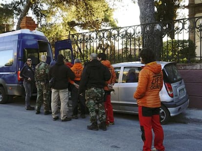 Greek officers lead Spanish volunteers from Proem-aid to a police van following their arrest with two Danish nationals in the Aegean Sea.