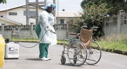 Una enfermera desinfecta una silla de ruedas en Ghana.