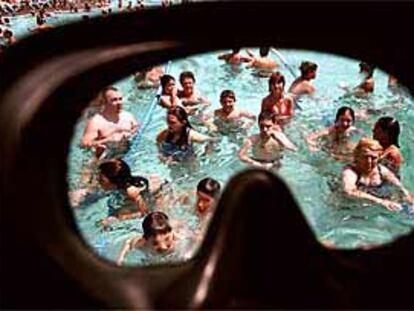 Algunos bañistas solidarios con Mulla't, en las piscinas de Diagonal, vistos a través de unas gafas de buceo.