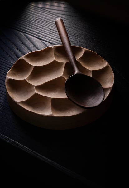 Hand-carved spoon and plate, both made from walnut wood.