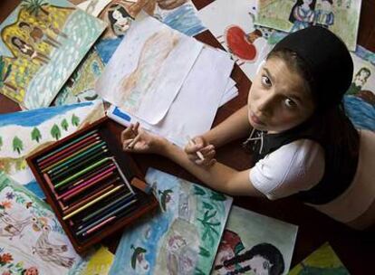 La niña Rebecca Covaciu pinta en la casa del sur de Italia donde se halla escondida.
