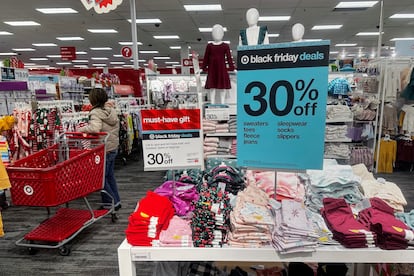 A shopper looks at clothes during Black Friday deals at a Target store in Westbury, New York, U.S., November 24, 2023.