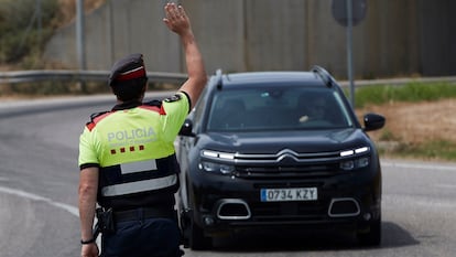 Regional police conducting road checks outside Soses, in Catalonia's Lleida province, where restrictions are in place due to a surge in coronavirus cases. 