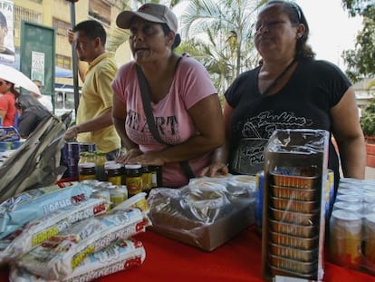 Un par de mujeres compran comida en un mercado estatal de Caracas.