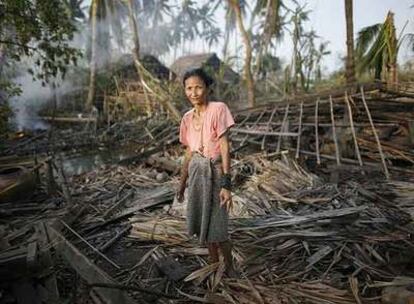 Una mujer observa los restos de su casa, destruida por el ciclón cerca de Kunyangon.