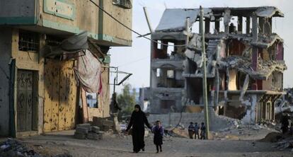 Uma mãe e seu filho, nas ruínas de Gaza.