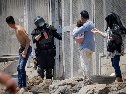 La policía española intenta dispersar a los migrantes en la frontera entre Marruecos y el enclave español de Ceuta, el martes.