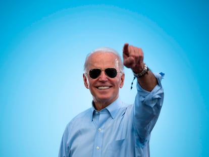 (FILES) In this file photo taken on October 29, 2020 Democratic Presidential candidate and former US Vice President Joe Biden gestures prior to delivering remarks at a Drive-in event in Coconut Creek, Florida. - Joe Biden has won the US presidency over Donald Trump, TV networks projected on November 7, 2020, a victory sealed after the Democrat claimed several key battleground states won by the Republican incumbent in 2016. CNN, NBC News and CBS News called the race in his favor, after projecting he had won the decisive state of Pennsylvania. His running mate, US Senator Kamala Harris, has become the first woman US Vice President elected to the office. (Photo by JIM WATSON / AFP)