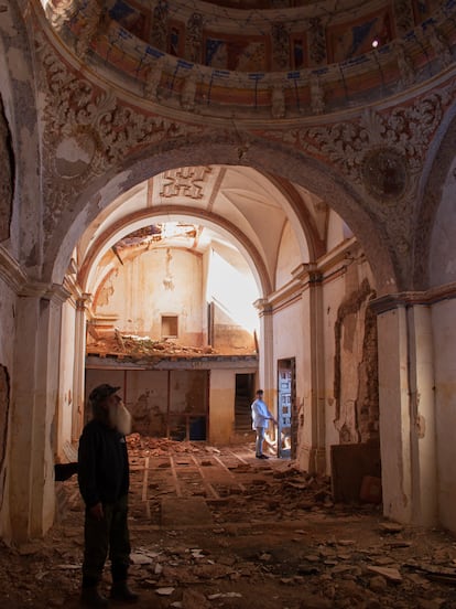 El vecino Ramiro Calvo, en primer plano, bajo la bóveda barroca del templo de Nuestra Señora de la Asunción (Cabreriza, Soria). 