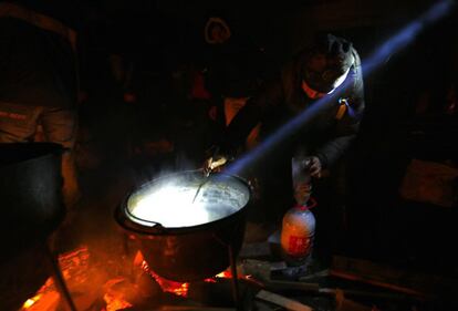 La capital ucraniana pasó una noche de tensa calma tras la sangrienta jornada del jueves en la que los enfrentamientos entre los manifestantes y las fuerzas de seguridad se cobraron decenas de vidas y centenares de heridos. En la imagen, un hombre prepara comida en la plaza de la Independencia de Kiev. 