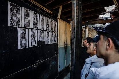 Un grupo de familiares observan las fotos de fallecidos en una pared del hospital Muytahed de Damasco.