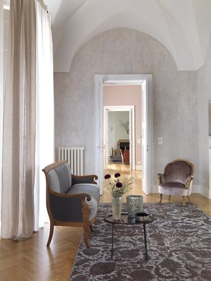 <P>El amplio pasillo tiene zonas de descanso con butacas retapizadas por la propia Reale. La mesa de apoyo es también de Chehoma, y los jarrones, de la tienda Home Collection Interior. </p> <p> En el extremo más meridional de Italia, en el tacón de la península salentina, la ciudad de Lecce es conocida como “la Florencia del sur”, aunque sus mayores tesoros arquitectónicos no son renacentistas, sino barrocos. En pleno centro histórico, en una calle peatonal sembrada de comercios, se alza este edificio neoclásico, levantado por Bernardino Bernardini en el siglo XVIII y restaurado recientemente por el arquitecto local Raffaele Centonze. Una pareja encargó la reforma del piso principal, este con grandes ventanales y vistas sobre la calle, a Rosella Reale. La interiorista romana presume de ser “antiminimalista” y defiende que sus intervenciones deben aligerar el pasado, pero dejarlo hablar. Eso buscaban los propietarios de esta vivienda. Querían recuperar la generosidad original de los espacios, pero necesitaban una casa cómoda. ¿Cómo actualizar sin dañar la memoria? Reale lo hizo rescatando la escala original y conectando y arropando las estancias. En ellas hizo convivir mobiliario de la familia, retapizado o restaurado, con un mundo ecléctico y limpio de cortinajes pesados. Creó un hogar práctico y contemporáneo, pero que, lejos de borrar el pasado, le da voz en una nueva conversación. </p>