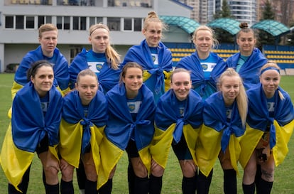 Players of a women's football team from Mariupol pose for photo before a Ukrainian championship match against Shakhtar in Kyiv, Ukraine, Tuesday, April 18, 2023