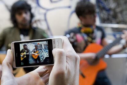 Uno de los participantes en el taller de videoclips para móviles grabando en el Raval.