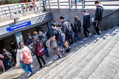 Estudiantes entran en la parada de metro de Ciudad Universitaria, en Madrid.