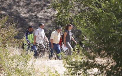 The latest victim (in red) is taken to the spot where she was found.