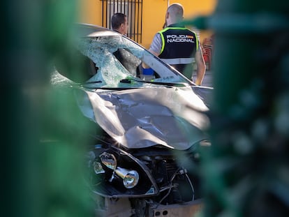 Agentes de la Policía Nacional, junto al vehículo involucrado en el atropello, este domingo en el cuartel de la Guardia Civil de Seseña (Toledo).