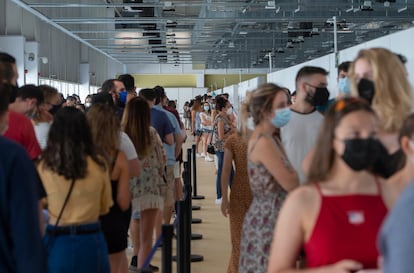 People wait in line to get vaccinated at the Isabel Zendal Hospital in Madrid.