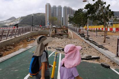 Los niños caminan por un camino dañado en Hong Kong, 
